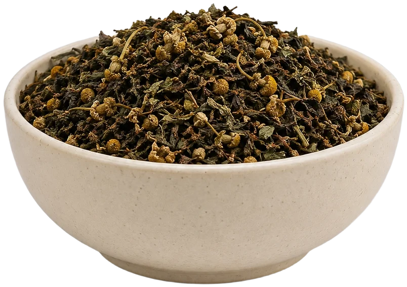 Ceramic bowl of herbs with a tea cup behind